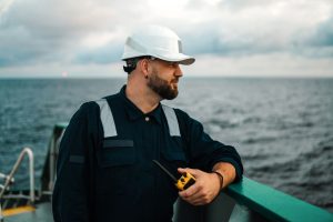 Seafarer with a helmet offshore